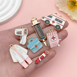 Detailed close-up of 7 medical enamel alloy pendants including ambulance and syringe