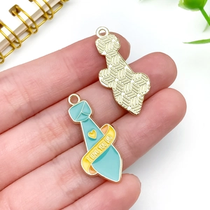 Detail of blue enamel tie charm with I Love You Dad lettering for DIY necklaces