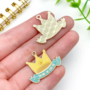 Detail of crown charms with 'YOU ARE THE KING DAD' text and gold-tone textured back