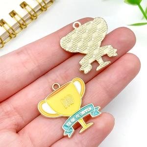 Detail view of gold trophy alloy pendant with DAD engraving for Father's Day jewelry making