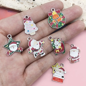 Christmas-themed alloy drip oil charms set featuring Santa and tree held in palm for scale