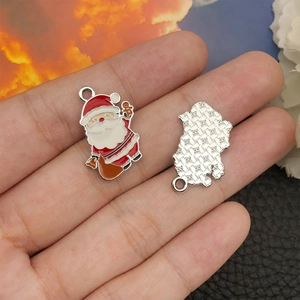 Detail of Santa Claus enamel charm for jewelry making with front and back metal grid view
