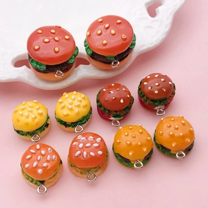 Macro view of realistic 3D resin hamburger pendants with colorful layered details