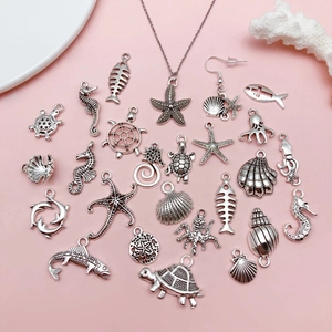 Silver marine ocean animal charms set with starfish and turtle on pink background