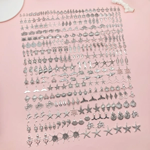 Detailed flat lay of silver sea creature charms including starfish, seahorse and shells