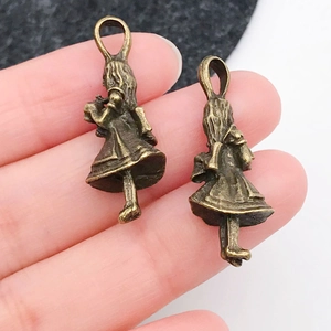 Makroansicht von Vintage-Bronze-Anhängern im Alice-Stil als Größenreferenz