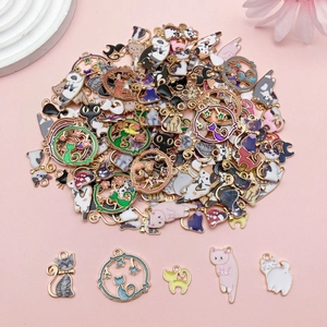Detailed view of colorful enamel cat charms with moon and star elements for DIY jewelry