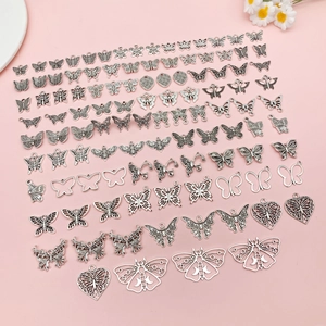 Detailed overhead view of antique silver butterfly alloy pendants for DIY jewelry making