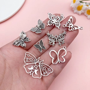 Detailed set of eight vintage silver alloy butterfly pendants for DIY jewelry crafting