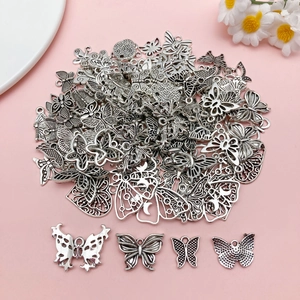 Macro shot of assorted silver alloy butterfly charms for DIY jewelry making and crafts