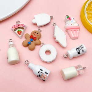 Macro detail of assorted resin DIY dessert charms featuring Milk bottles and gingerbread men