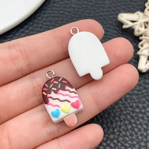 Detailed view of DIY resin ice cream charms with colorful sprinkles and metal loops