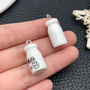 Detailed macro view of resin milk bottle pendant charms for DIY jewelry and keychain crafts