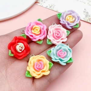 Set of six colorful resin camellia flower charms with green leaves for DIY jewelry making