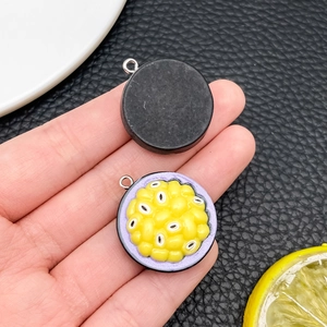 Macro detail of passion fruit resin pendant with purple shell and silver hook for DIY