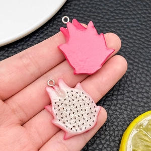 Macro shot of realistic dragon fruit resin charms for DIY jewelry and accessory making