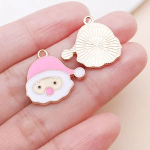 Macro view of pink Santa Claus alloy charm with detailed sunburst texture on the back