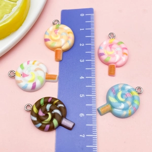 Macro shot of colorful resin lollipop pendants for DIY charms with metal hooks