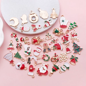 Macro shot of assorted Christmas enamel charms including reindeer and snowman styles