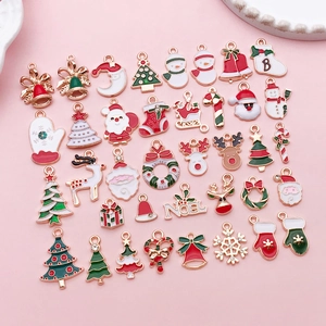 Flat lay of colorful enamel Christmas charms including Santa and reindeer for DIY jewelry