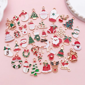 Flat lay of colorful Christmas alloy charms featuring Santa, reindeer, and snowman designs