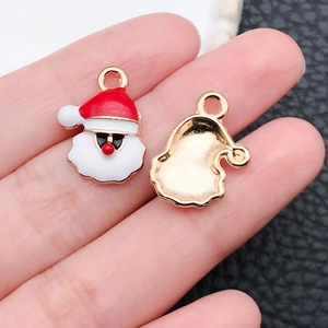 Macro shot of alloy Christmas Santa pendant with red enamel details and gold finish