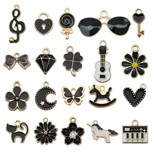 20-piece black and gold alloy DIY charms set including musical notes and hearts