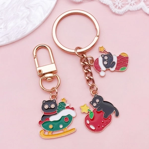 Set portachiavi gatto di Natale con ciondoli in smalto oro rosa e motivi festivi