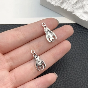 Macro shot of double-sided retro silver bat pendant for DIY jewelry making and crafts