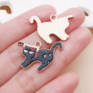 Detail of cartoon black cat enamel charms with gold plating and knife design for jewelry