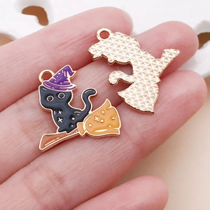 Detail of Halloween black cat enamel charm showing wizard hat and golden textured back