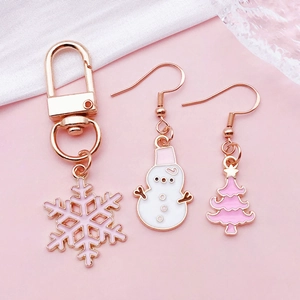 Pink and white Christmas alloy charm set with snowflake keychain and festive earrings