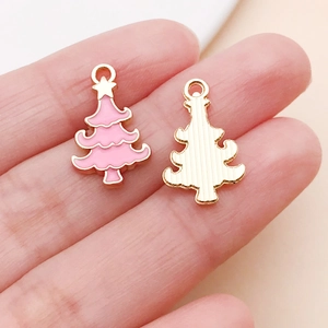 Detailed macro view of pink enamel Christmas tree charm for DIY jewelry making