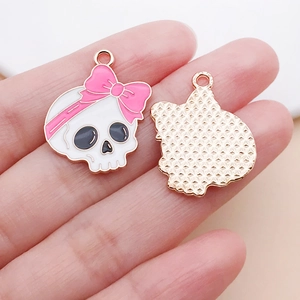 Macro view showing both sides of pink bow skull pendant with gold mesh texture