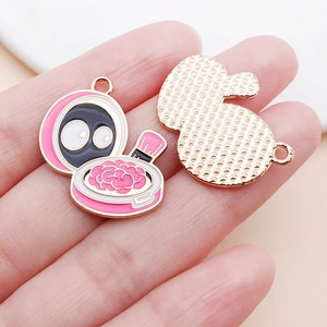 Macro detail of rose gold enamel cosmetic box pendant with cartoon face for DIY jewelry