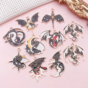 Macro shot of 10 Gothic dragon moon alloy charms with enamel detailing for DIY jewelry