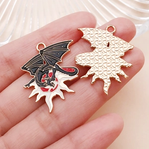 Close-up of golden dragon moon enamel charms with black and red drip oil DIY details