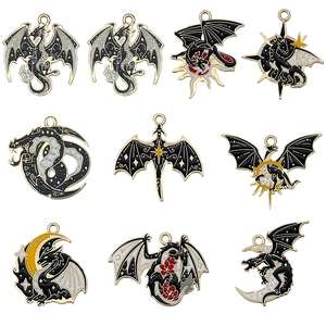 Set of nine dark fantasy dragon and moon enamel charms with black and gold details