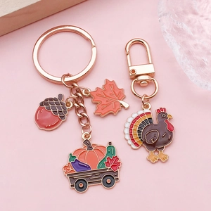 Thanksgiving keychain with maple leaf and turkey charms in rose gold alloy finish