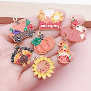 Detail of Thanksgiving enamel charm set featuring turkey and pumpkin designs