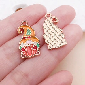 Macro detail of alloy enamel gnome pendant showing intricate colorful front and textured back