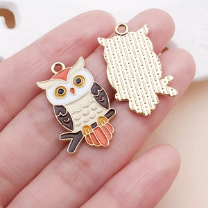 Macro shot of colorful owl enamel alloy pendants for DIY jewelry making