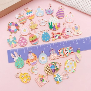 Macro view of pastel enamel Easter pendants showing exact sizing on a purple ruler