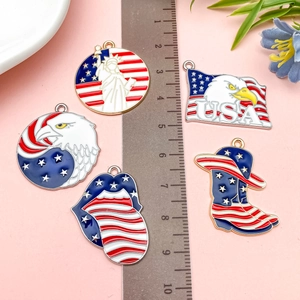 Detailed size view of Patriotic USA themed enamel charms with eagle and statue motifs
