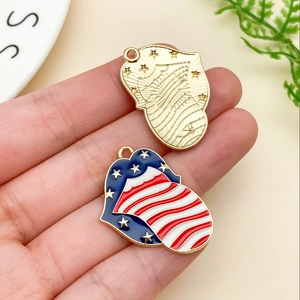Detailed macro of patriotic heart and lip charms with American flag enamel and gold texture