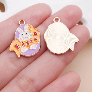 Detail of Easter bunny charms with purple enamel and gold-plated metal backing for DIY