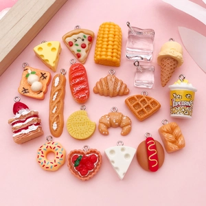 Macro shot of assorted resin food charms like popcorn and donuts with silver rings