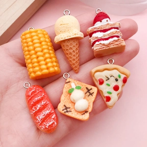 Detailed view of assorted 3D resin food pendants for DIY crafts and phone chains