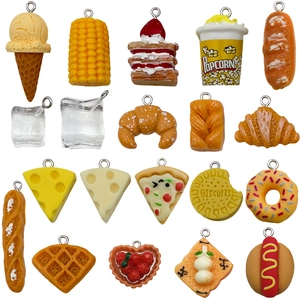 Assorted miniature food charms including popcorn and croissants with metal rings