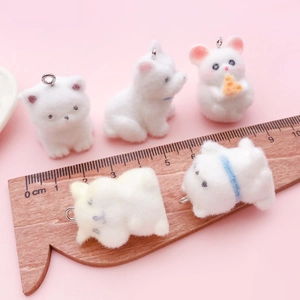 Five cute white flocked resin puppy and kitten charms with metal hooks on pink backdrop